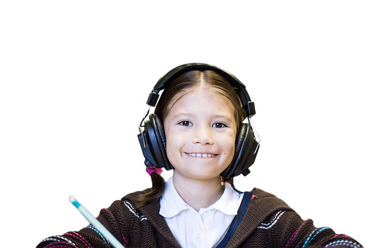 A pupil in headphones at her desk — the original, where she can be identified