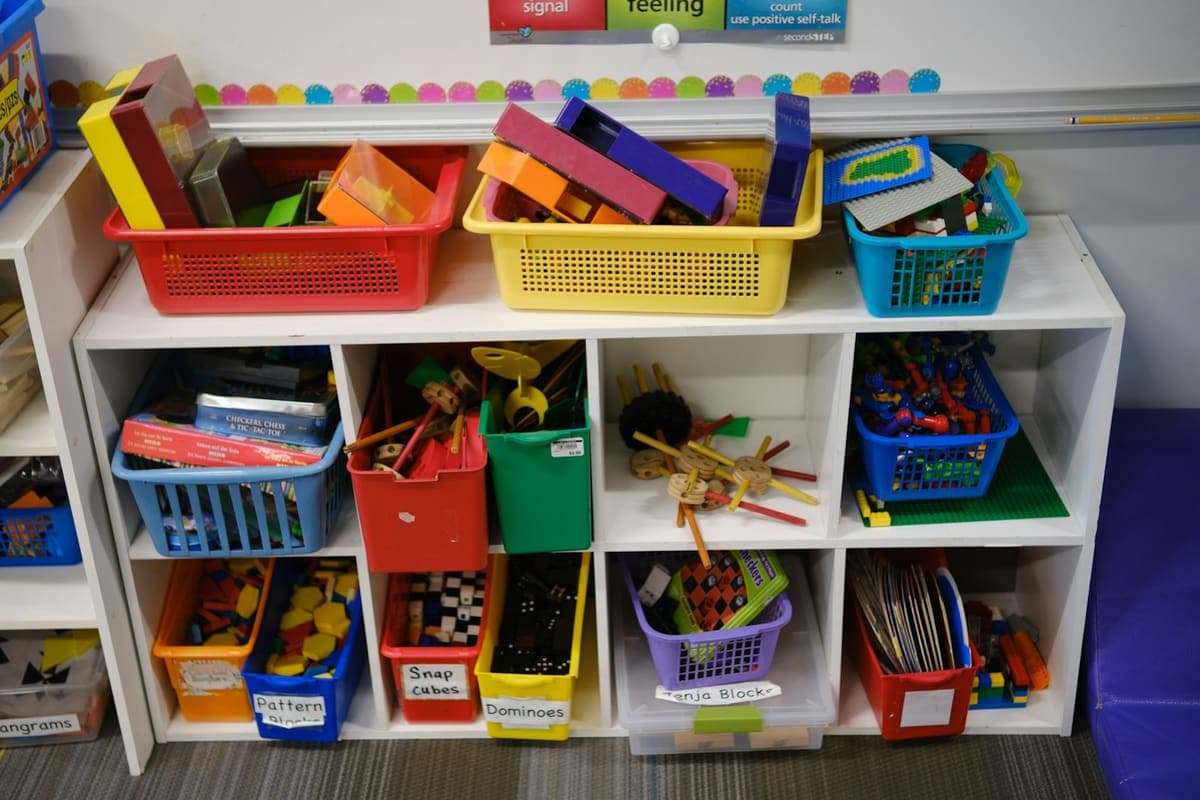 Colourful toy baskets on nursery shelves